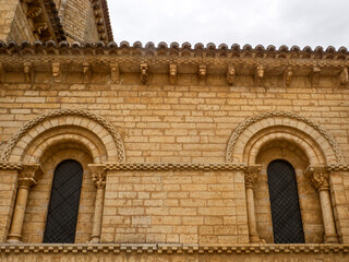 Romanesque arched windows and carved corbels on the facade of the Church of San Martin de Tours in Fromista, Spaina