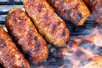 Pork chops, steak, sausages on barbecue grill