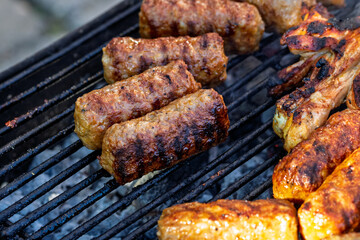 Pork chops, steak, sausages on barbecue grill