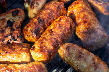 Pork chops, steak, sausages on barbecue grill