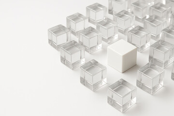 Obraz premium One white cube stands out among the transparent cubes. Space for text.