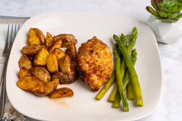  chicken thigh   with asparagu and  potato wedges
