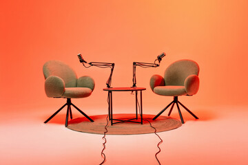Podcast studio setup with chairs and microphones against a vibrant background
