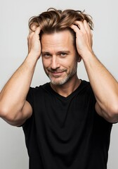 Fototapeta premium High-resolution photorealistic studio image of a man after successful hair transplant, self-assessing his natural full hairline with confidence on clean white background