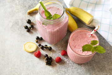 Refreshing mixed berry and banana smoothie with mint garnish. Copy space.