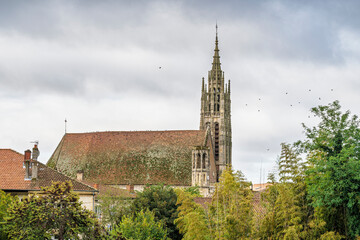 Cityscape view of ancient Saint Hilaire church in autumn under overcast sky, Agen, Lot-et-Garonne, France