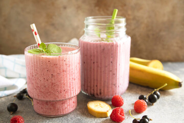 Refreshing mixed berry and banana smoothie with mint garnish.