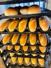 Food commerce and everyday shopping. Sale of bread with a close-up view of bakery products on shelves in a store or bakery.
