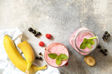 Refreshing mixed berry and banana smoothie with mint garnish.