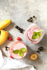 Refreshing mixed berry and banana smoothie with mint garnish.