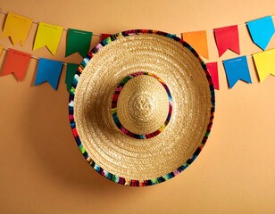 Festive sombrero on a beige background with colorful streamers