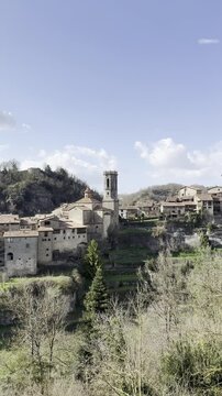 The charming medieval village of Rupit. The video shows its stone houses with wooden balconies and flowers, cobblestone streets, and its mountainous natural surroundings. Rupit, Spain