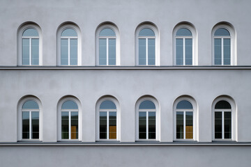 Obraz premium Architectural beauty of arched windows on modern building exterior