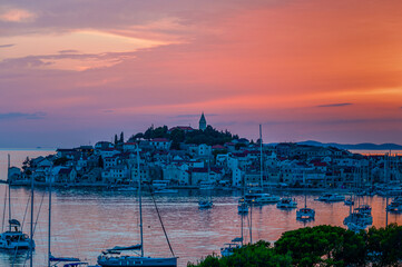 beautiful croatian mediterranean town at sunset with boats in the foreground