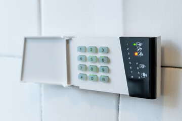 Security alarm system keypad mounted on a home wall for easy access and control