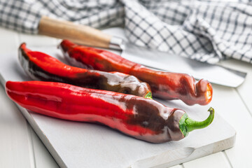 Corno di Toro Rosso pepper. Red paprika vegetable on cutting board.