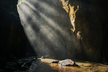 Gorge with rocky vaults. sunlight streaming through a rocky cave in Majalengka, West Java,...