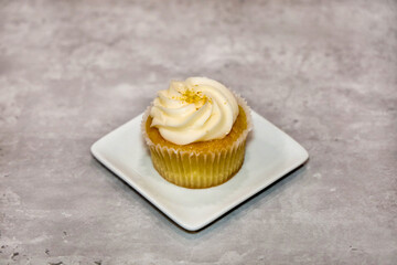 Close-up view of a vanilla cupcake with buttercream frosting.