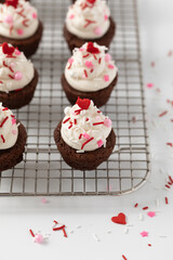 Brownie Rounds with Vanilla Buttercream Icing and Valentine Sprinkles on a Cooling Rack