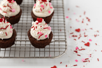 Brownie Rounds with Vanilla Buttercream Icing and Valentine Sprinkles on a Cooling Rack