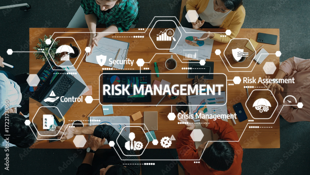 Poster a diverse team engaged in a risk management session, analyzing data and strategies on a table filled