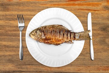 Tasty fresh fish dish on desk background
