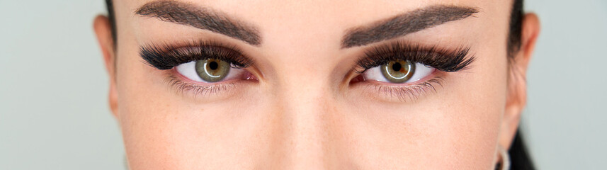 Obraz premium Cropped female face with long eyelashes closeup