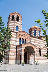 Fototapeta premium Exterior of Saint Nicholas Church with tree leaves in summer. Batumi, Adjara region, Georgia.