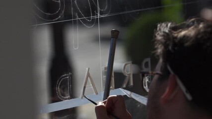 Sign Making by enameling on glass with technical artistry