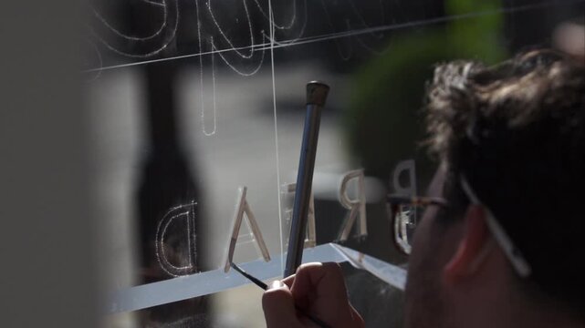 Sign Making by enameling on glass with technical artistry