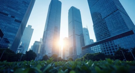 Naklejka na ściany i meble Looking up at imposing modern skyscrapers on a clear day with sunlight shining through