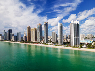 Obraz premium Contemporary Oceanfront Towers in Miami, Florida. Peaceful Beach and Blue Sky