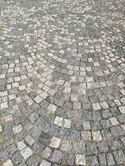 Cobblestone pavement featuring an intricate circular pattern that draws the eye