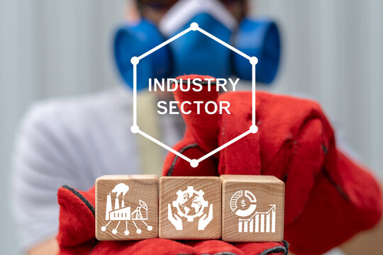 Engineer holding wooden blocks with icons presses virtual button with inscription: INDUSTRY SECTOR. Concept of industry sector. Industrial sectoral services and technology.
