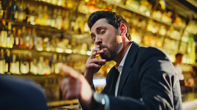 Laughing gentleman smoking rollup golden lounge closeup. Man enjoying cigarette