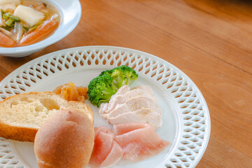 Healthy breakfast with bread, ham, chicken breast and broccoli
