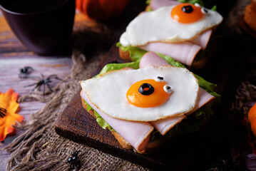 Sandwich with ham and fried egg in the form of ghost for Halloween holidays