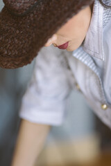 Indoor portrait of a young beautiful fashionable woman wearing stylish accessories.