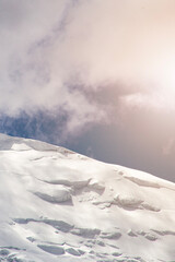 A close-up of a mountain peak in bad weather, leading to the death of climbers in windy weather, snow-capped peaks in the clouds