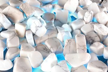 White polished stones texture background and blue light