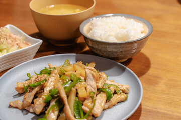 Japanese dinner with pork stir fry, rice, miso soup and salad
