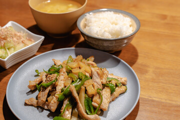 Japanese dinner with pork stir fry, rice, miso soup and salad
