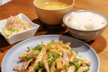 Japanese dinner with pork stir fry, rice, miso soup and salad
