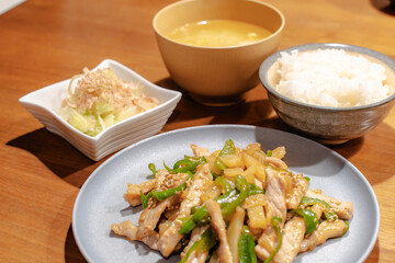 Japanese dinner with pork stir fry, rice, miso soup and salad
