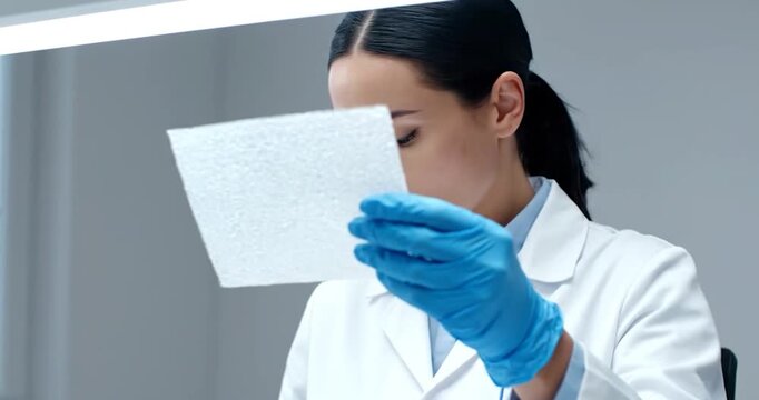 Scientist Inspecting Recycled Biodegradable Packaging Prototype. Quality, material, innovation concept.