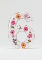 Floral number six made from resin with colorful flowers embedded  