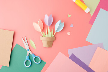 DIY paper flower arrangement with color sheets, leaves and heart shapes on workspace, perfect for craft stores, floral event stylists, holiday workshop organizers, kids activity brands