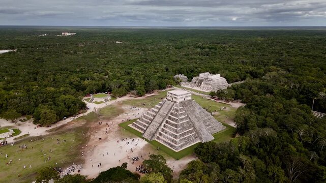 Extended orbit shot of the Temple of Kukulcan at Chichen Itza in Yucatan, Mexico, showcasing its ancient stone architecture and jungle surroundings