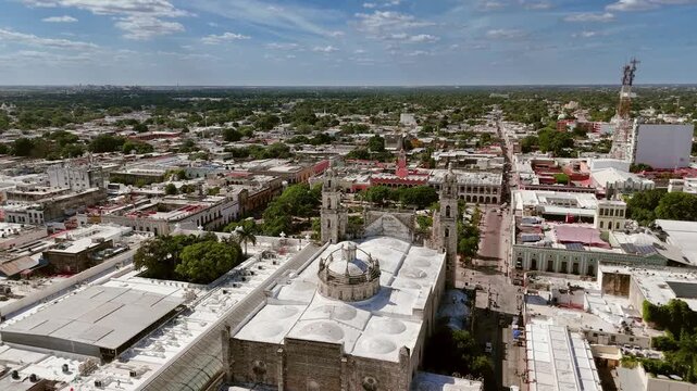 Long push-in drone shot over the colonial skyline of Merida in Yucatan, Mexico, revealing the historic city center