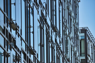 Obraz premium blue glass wall of office building mirror reflection